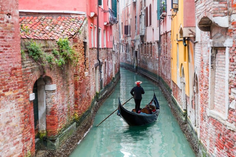 Man rowing Gondola in a canal