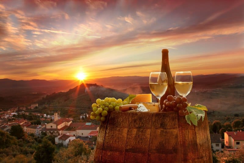 Wine on a barrel and a sunset view at chianti tuscany