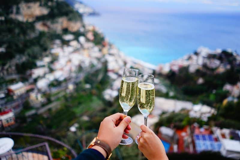 Couple with glasses of Champagne at Positano, Italy.