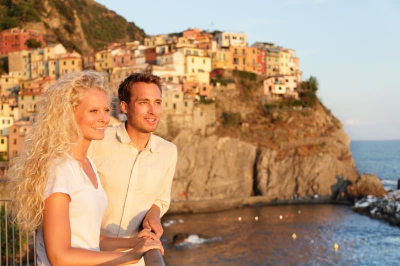 Young beautiful couple enjoying ocean view At Cinque Terre