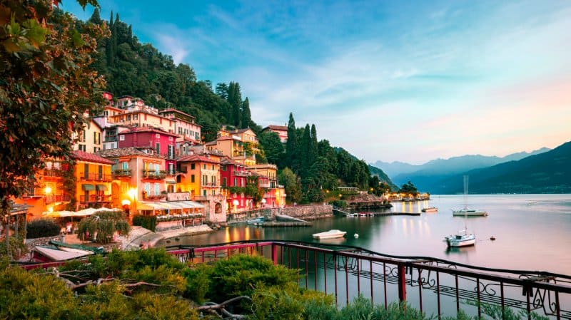Colorful houses, speed boat at Lake Como, Italy