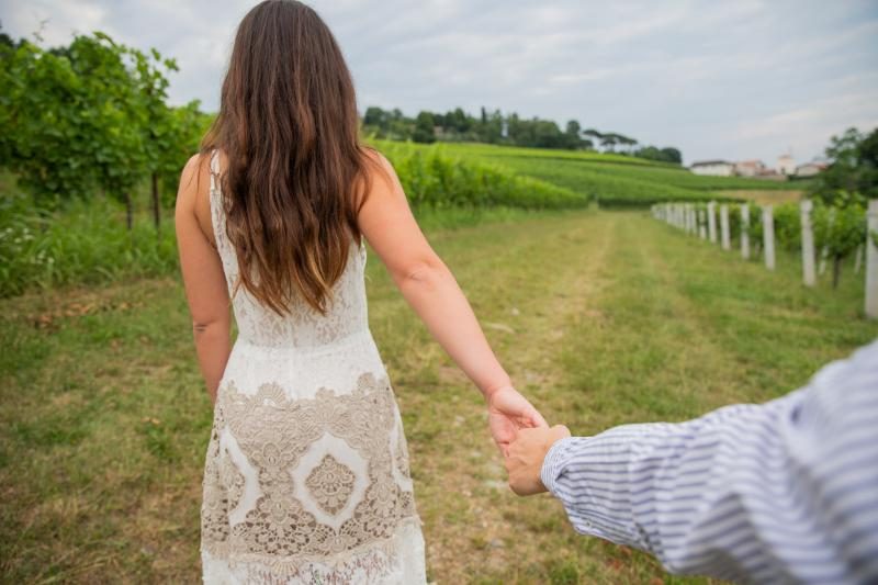 Boyfriend holding hand of fiancee