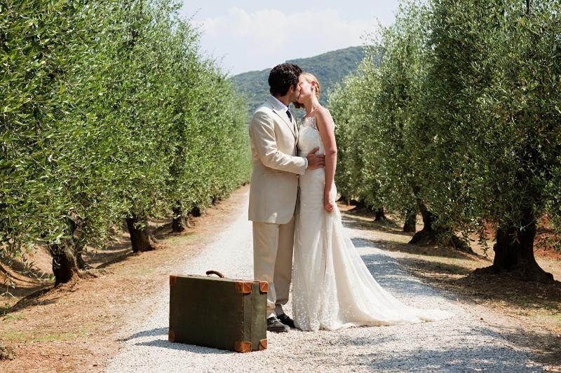 Newly weds kiss at a vineyard location