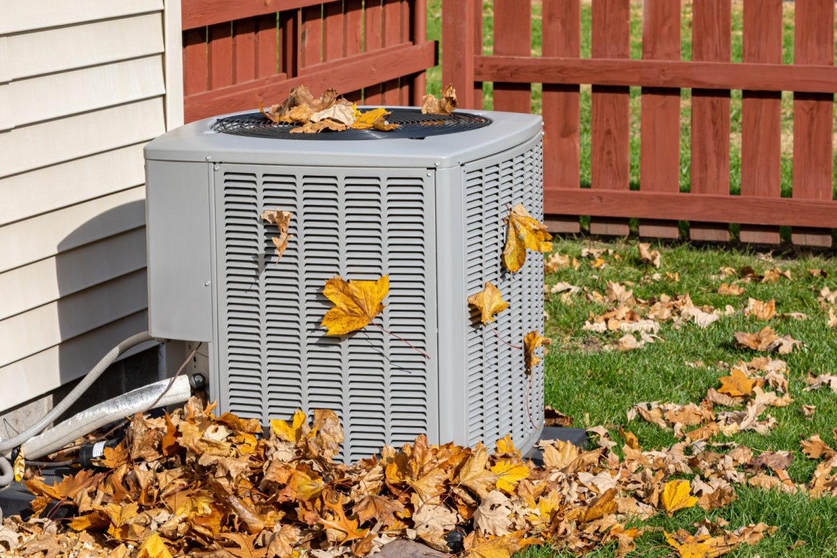 Dirty air conditioning HVAC system and unit covered in leaves