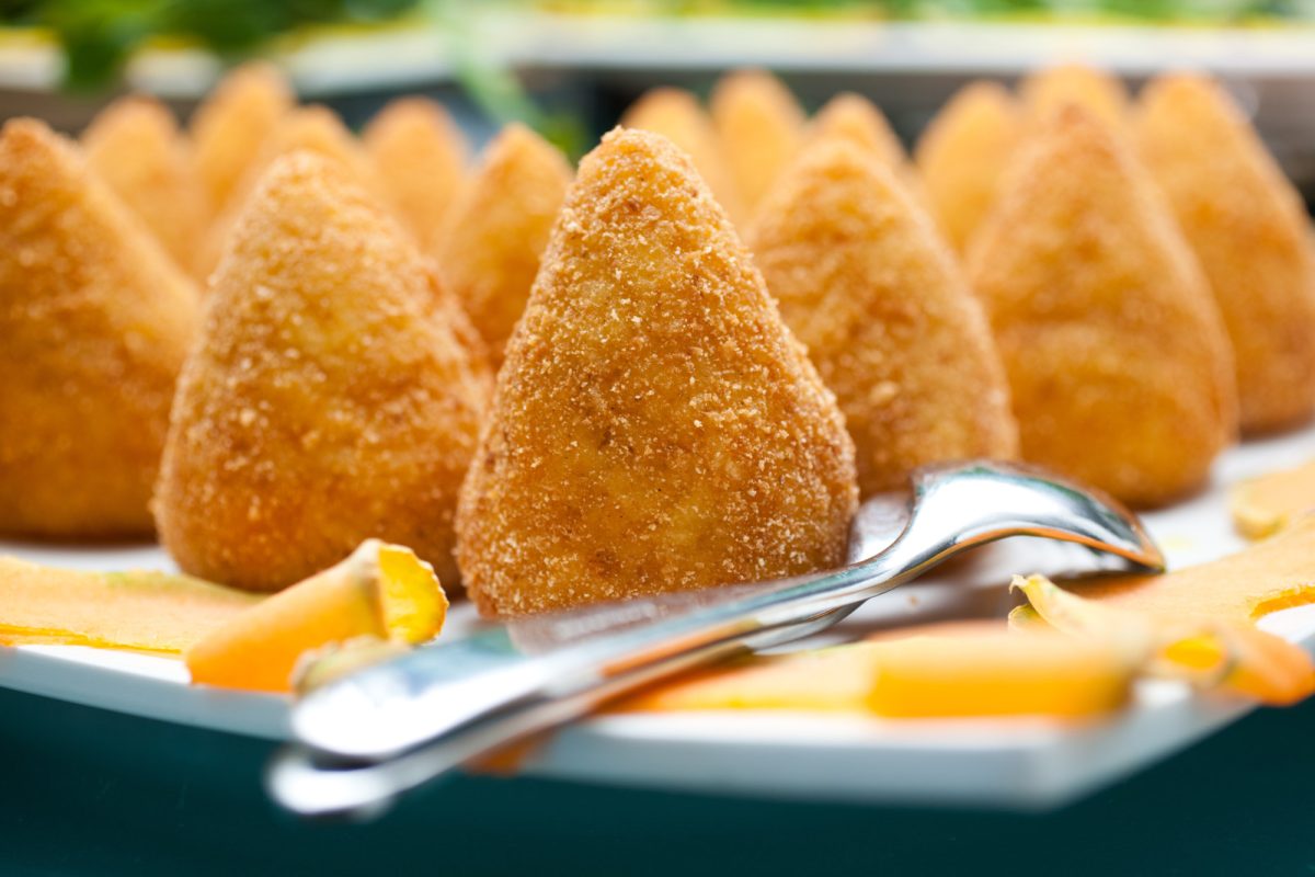 Close-up of Arancini rice balls with spoon and fork