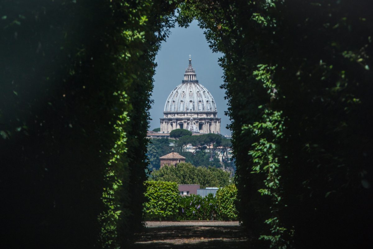 View of the dome of Saint Peter's Basilica through the Aventine Keyhole, or the keyhole at the gate of the Priory of the Knights of Malta on Aventine Hill, Rome, Italy