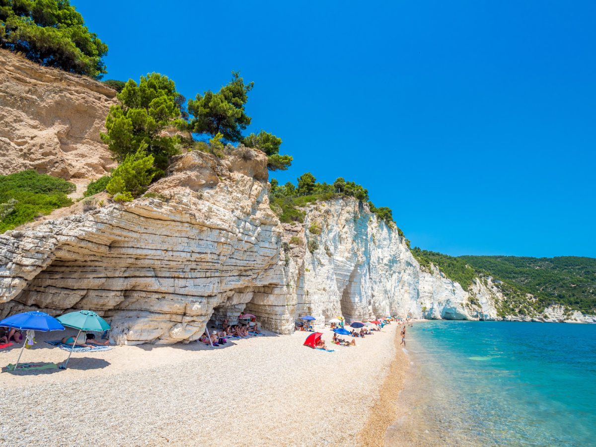 Baia Delle Zagare beach coast and tourists in Puglia, Italy