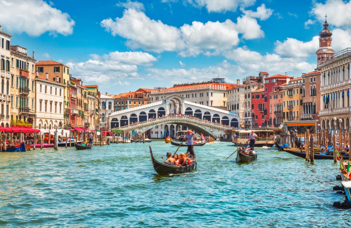 Gondola ride and Bridge Rialto in Venice, Italy