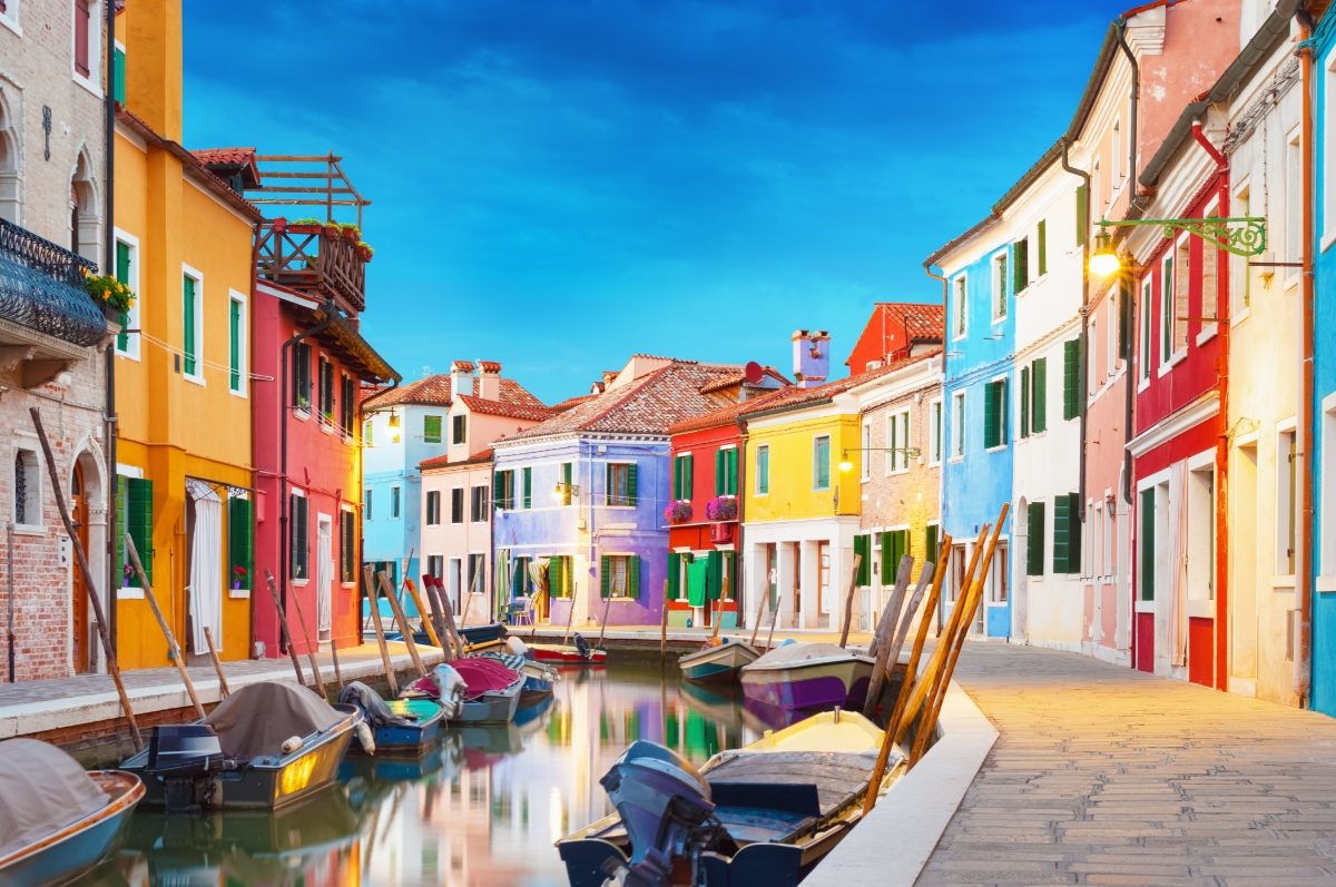 Colorful houses and boats in Burano, Venice, Italy