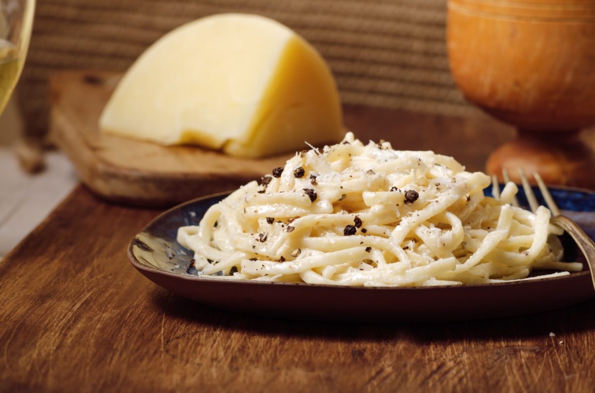 Close-up of a Cacio e pepe pasta made with grated Pecorino Romano cheese, pasta, and black pepper