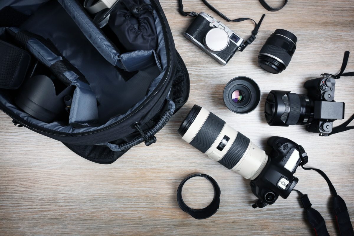 Top view of a camera backpack and different camera equipment