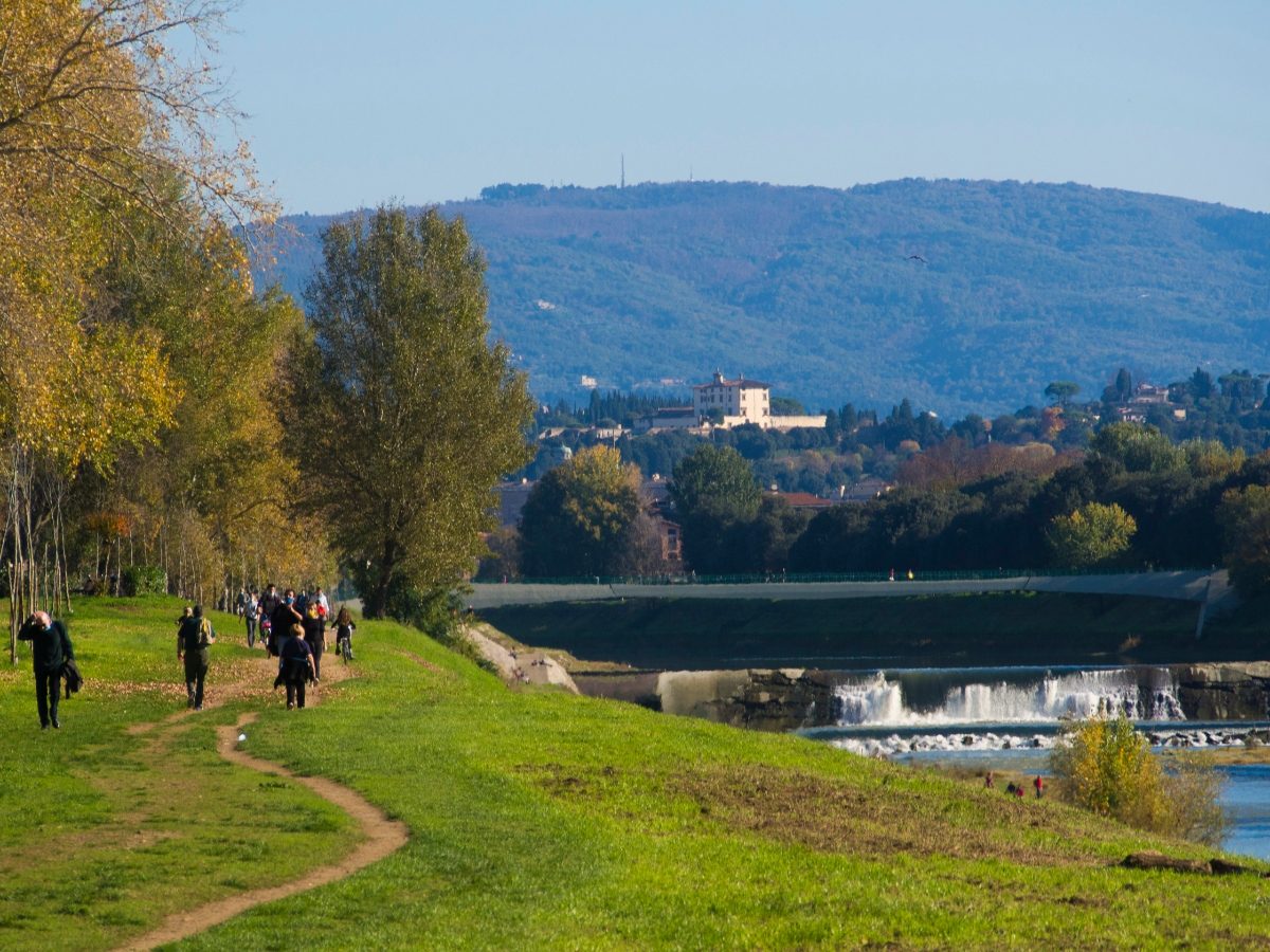 Panoramic view of locals and tourists exploring the trails at Cascine Park in Florence, Italy