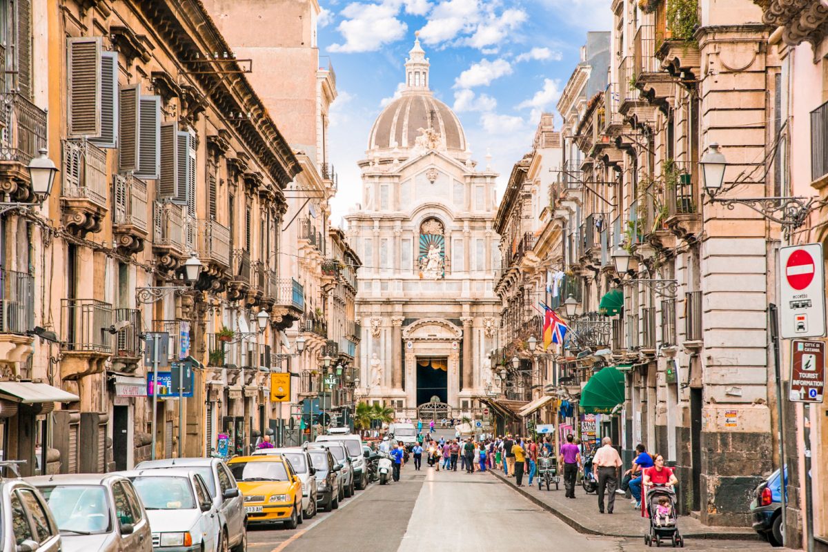 Busy street filled with cars and people in Catania, Sicily, Italy