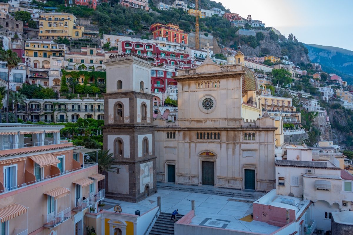 Facade of the Chiesa di Santa Maria Assunta church and town view of the Positano in Amalfi Coast, Italy