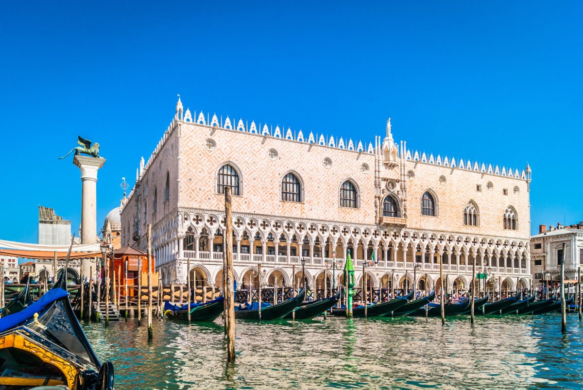 Exterior of the Doge's Palace and row of gondolas in Venice, Italy