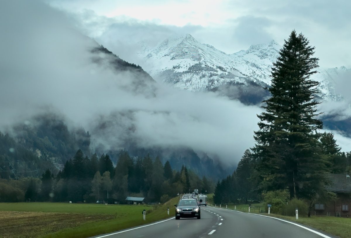 Cars driving and passing at a highway in Dolomites, Italy