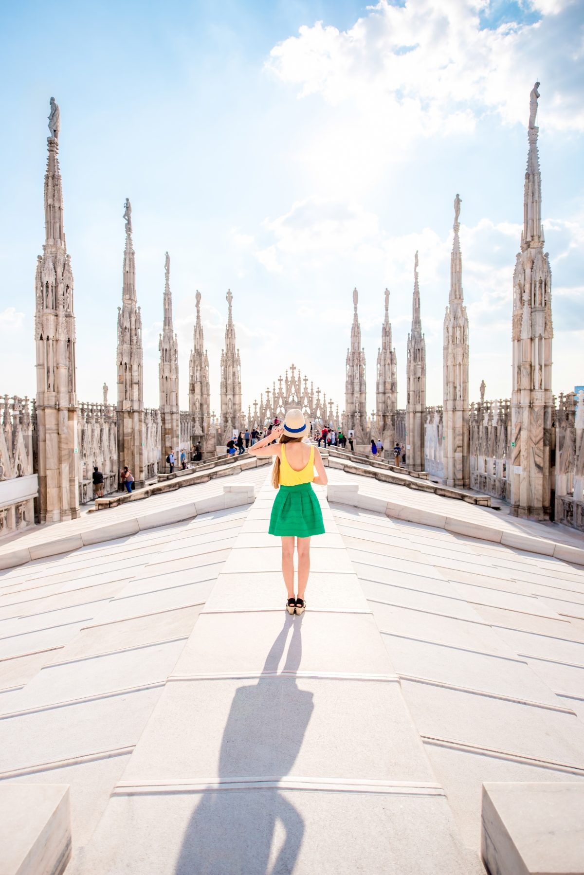 Female tourist wearing a stylish outfit while exploring the rooftop of Duomo cathedral in Milan, Italy