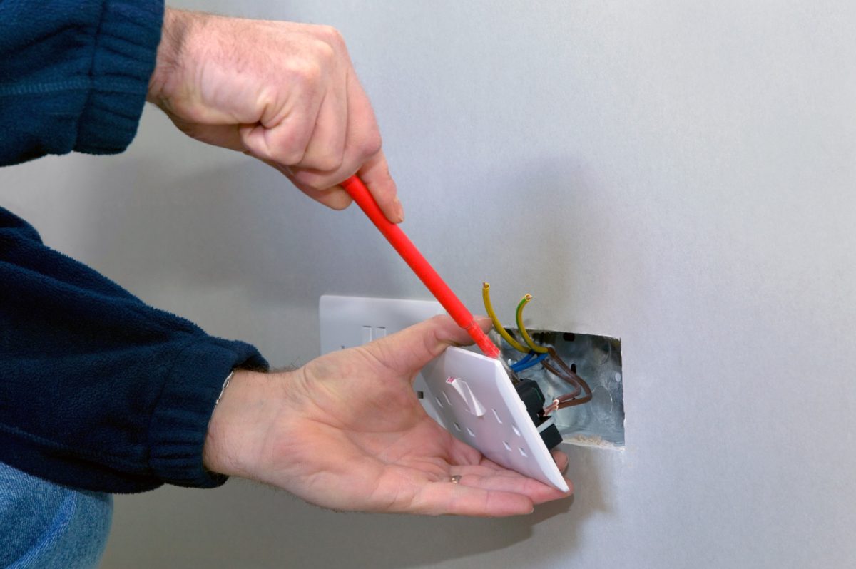 Electrician installing a new power socket