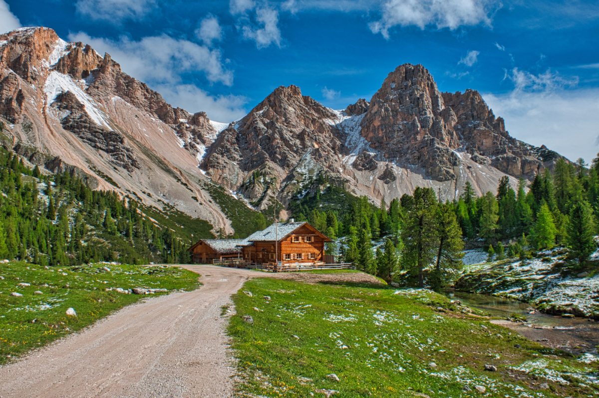 Hut, hiking trail and the mountain views at the Fanes Valley in Alta Via 1, Dolomites, Italy