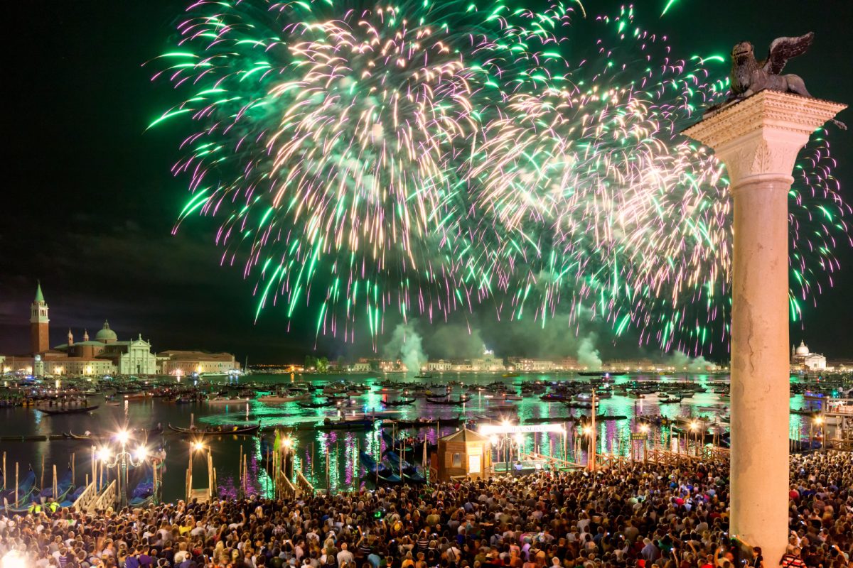 Panoramic view of the fireworks and crowd at Festa del Redentore celebration in Venice, Italy