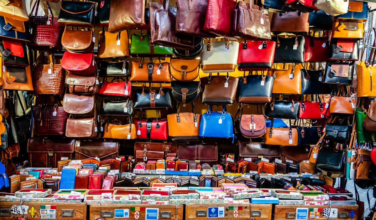 Leather bags and goods for sale at a market in Florence, Italy