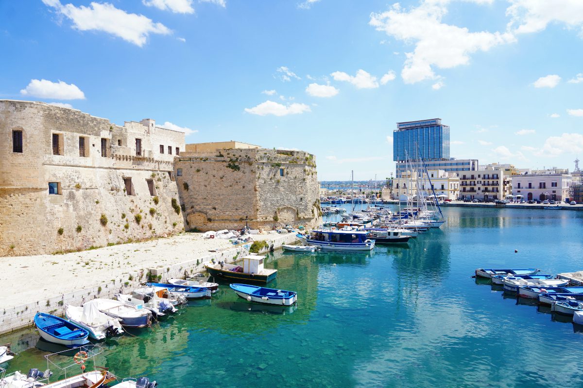 Old port of Gallipoli with castle and boats in Apulia, Italy