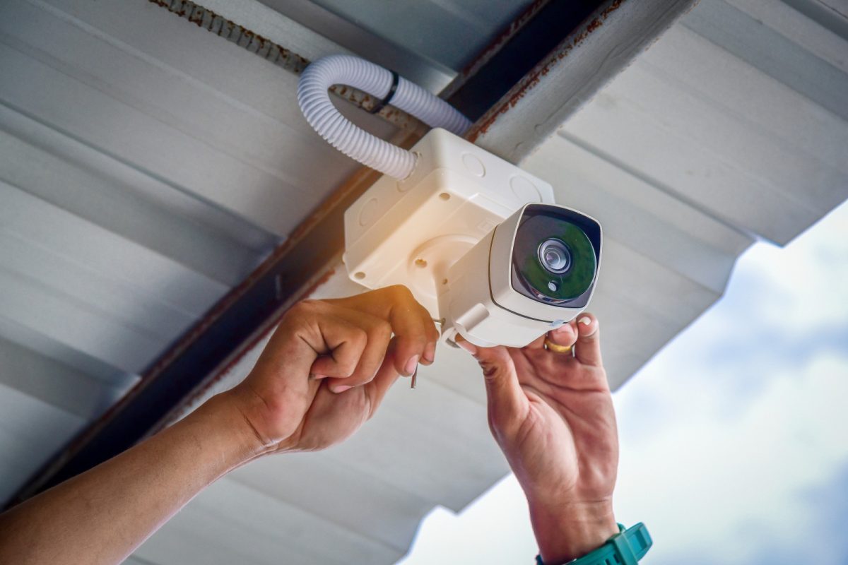 Technician installing CCTV camera security system