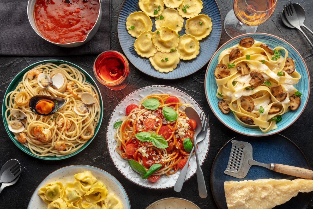 Table full of different Italian food and pasta