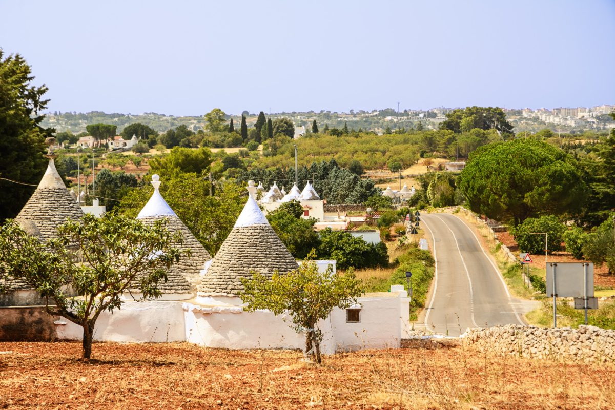 Trulli houses, olive trees, and Itria Valley countryside in Puglia, Italy  