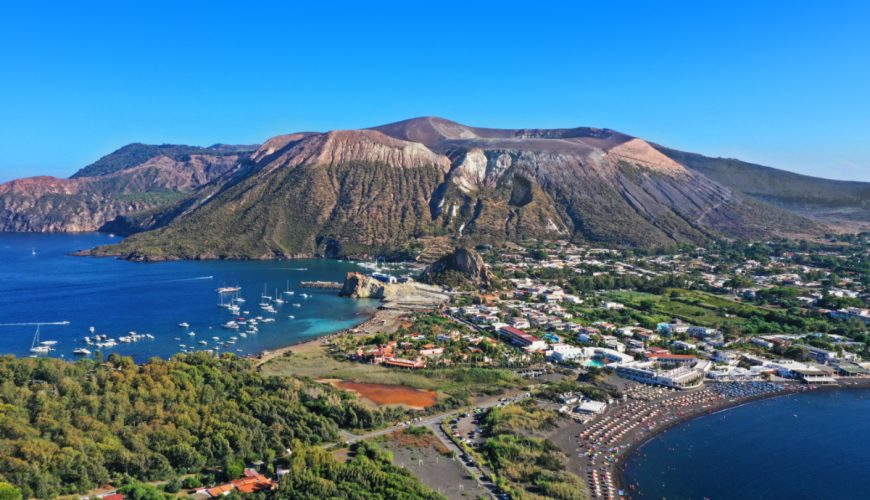 Aerial view of Vulcano Island showcasing its rugged terrain and volcanic features, surrounded by the blue waters of the Aeolian Islands