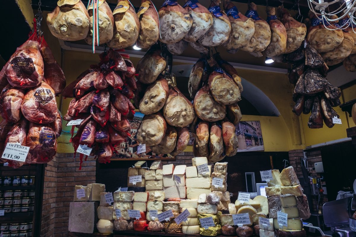 Prosciutto  and cheese shop on the covered indoor food market of Mercato di Mezzo in Bologna, Italy