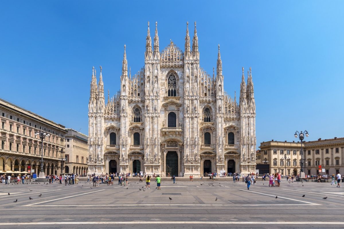 Locals and tourists strolling in front of the architectural masterpiece, Milan Duomo, in Milan, Italy