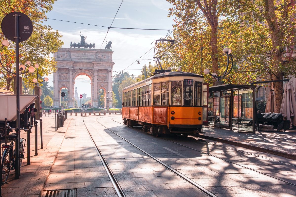 Vintage tram passing through the Arco della Pace in Milan, Italy