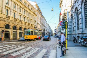 Tram and traffic on a busy street in Milan, Italy