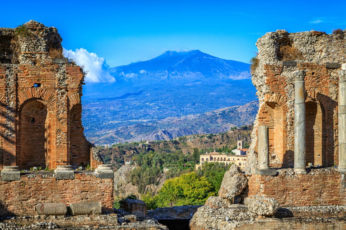 Panoramic view of Greek Theatre Ruins and Mount Etna in Sicily, Italy