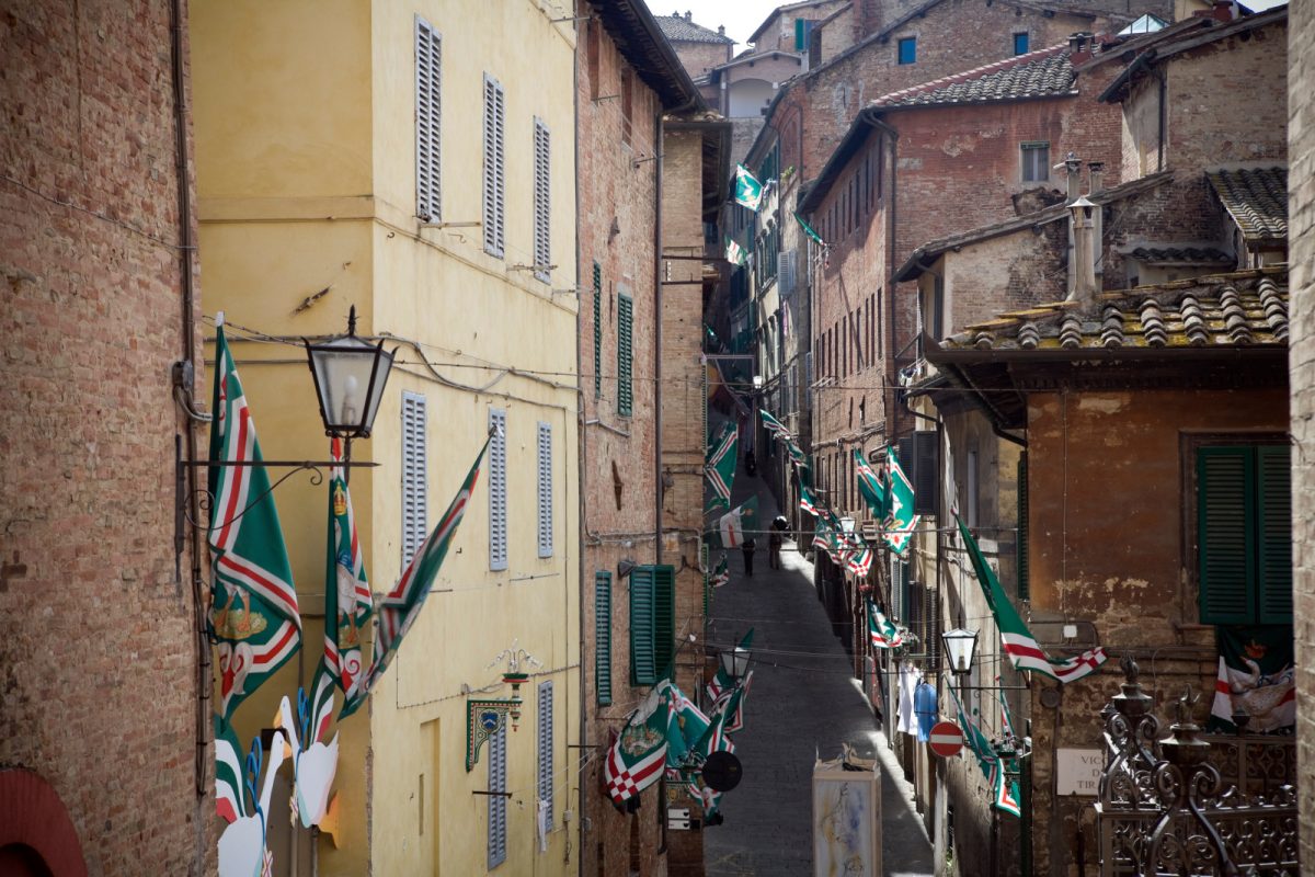 Streets filled with flags for the Palio di Siena or the Siena's Palio Horse Race in Sienna, Italy