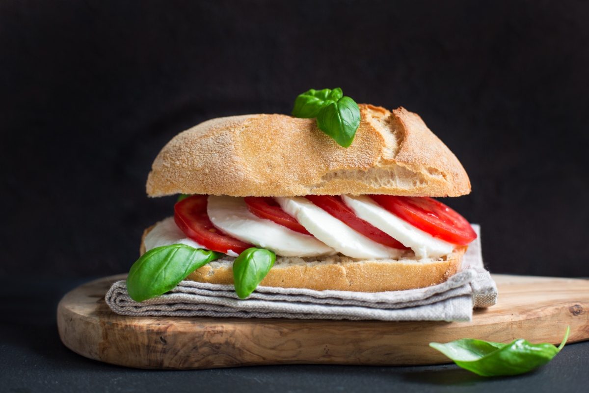 Close-up of the Panino Caprese sandwich with mozzarella, tomatoes, and basil