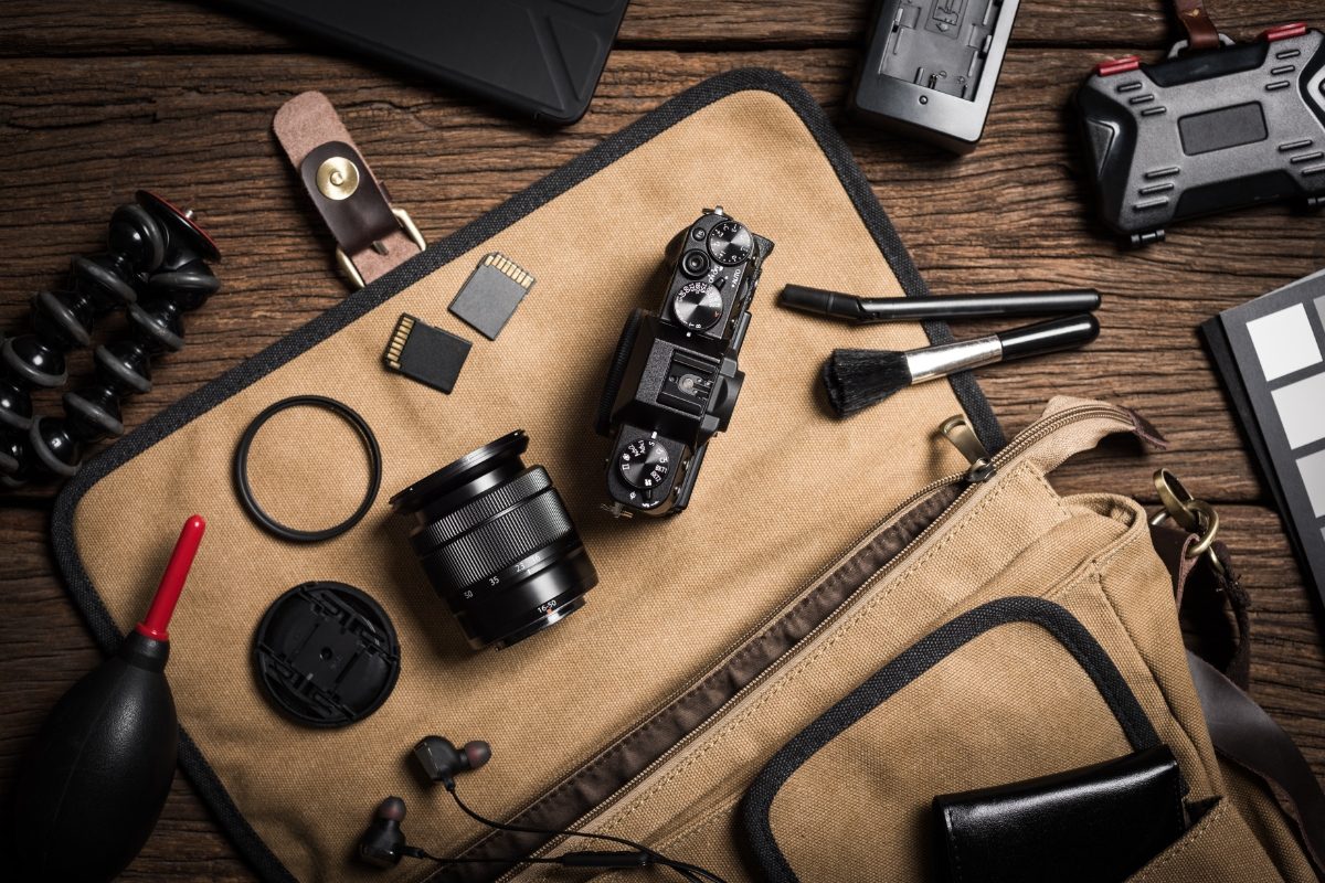 Close-up of different photography equipment on a wooden table