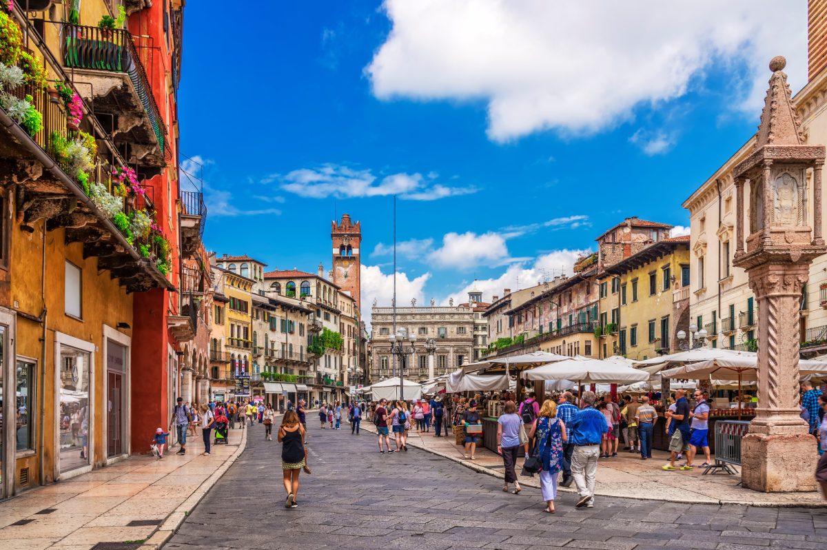 Piazza Delle Erbe market, tourists, and locals in Verona, Italy