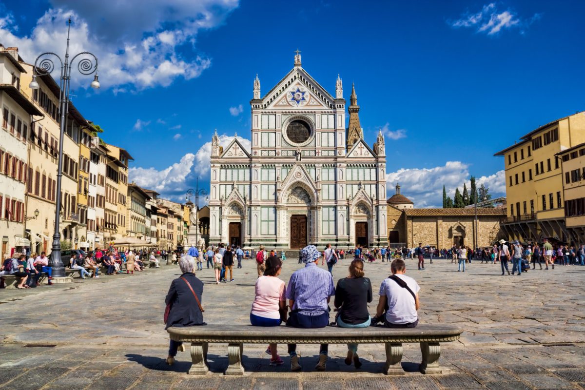 Tourists and locals exploring the Piazza di Santa Croce in Florence, Italy