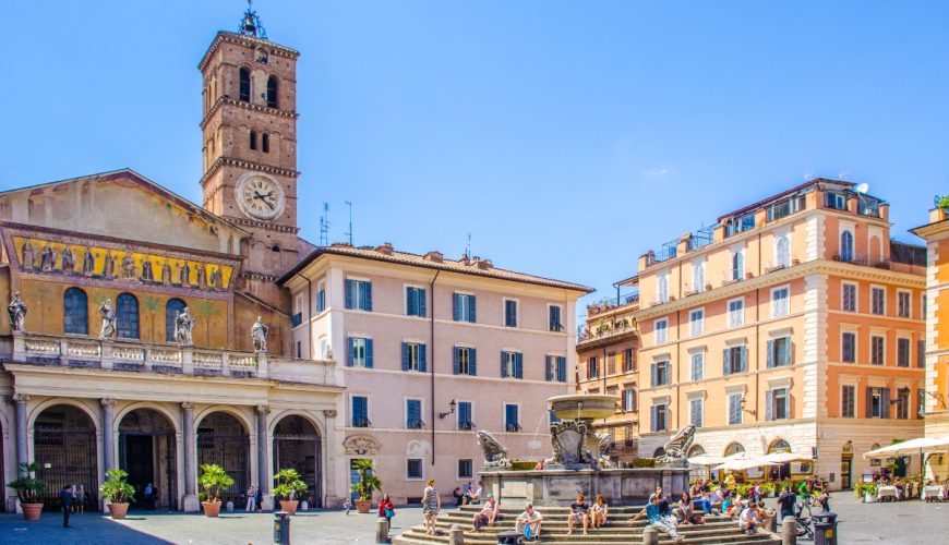 Locals and tourists strolling through Piazza di Santa Maria, located in front of the basilica in the Trastevere district of Rome, Italy