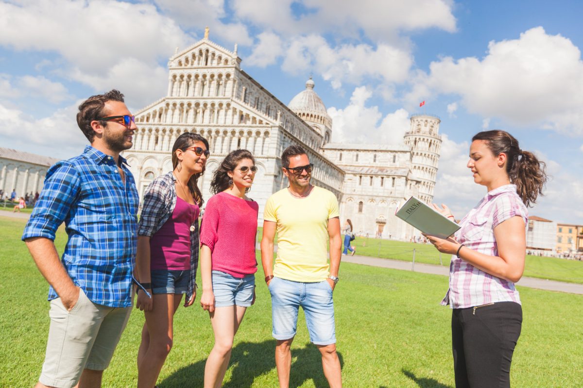 Tourists with a tour guide in Pisa, Italy