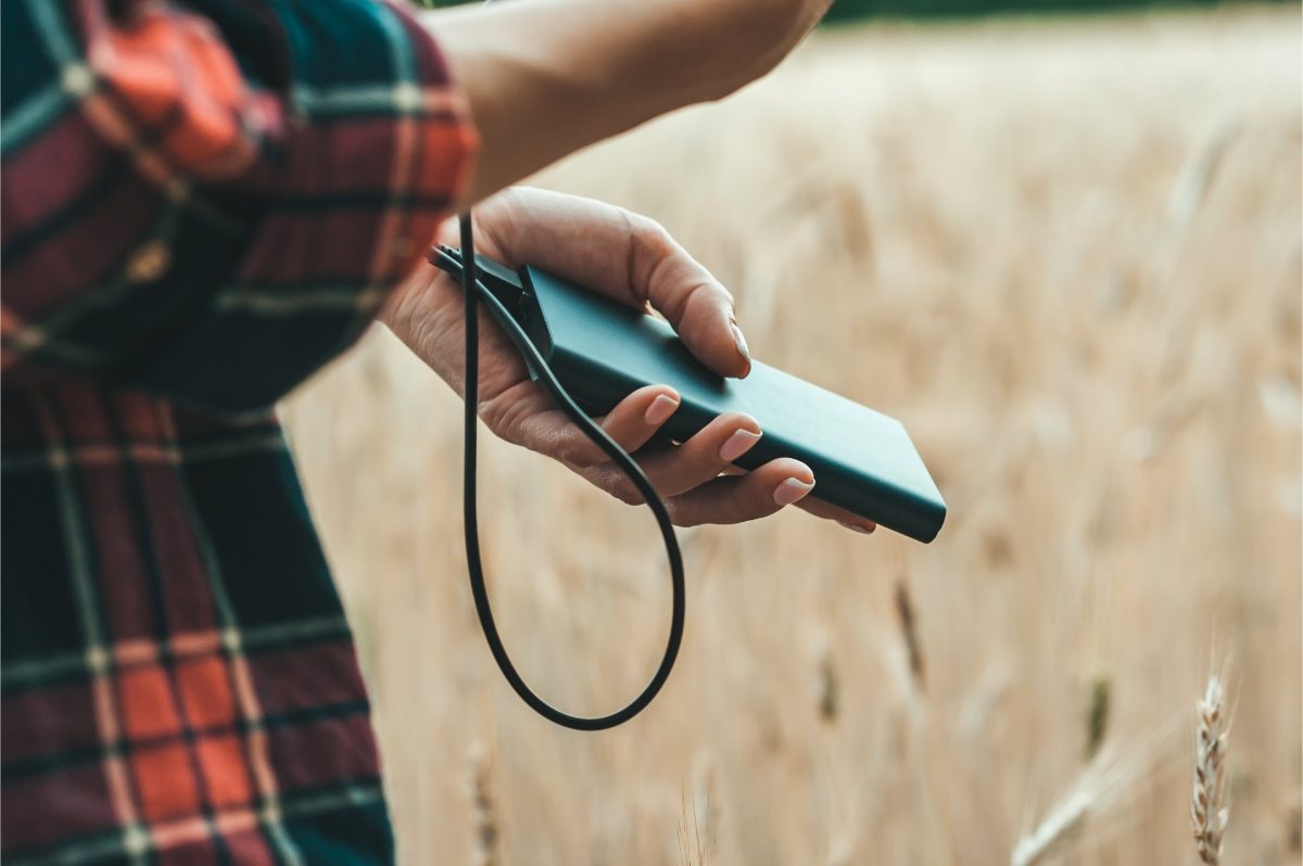 Man holding and using a power bank or a portable charger