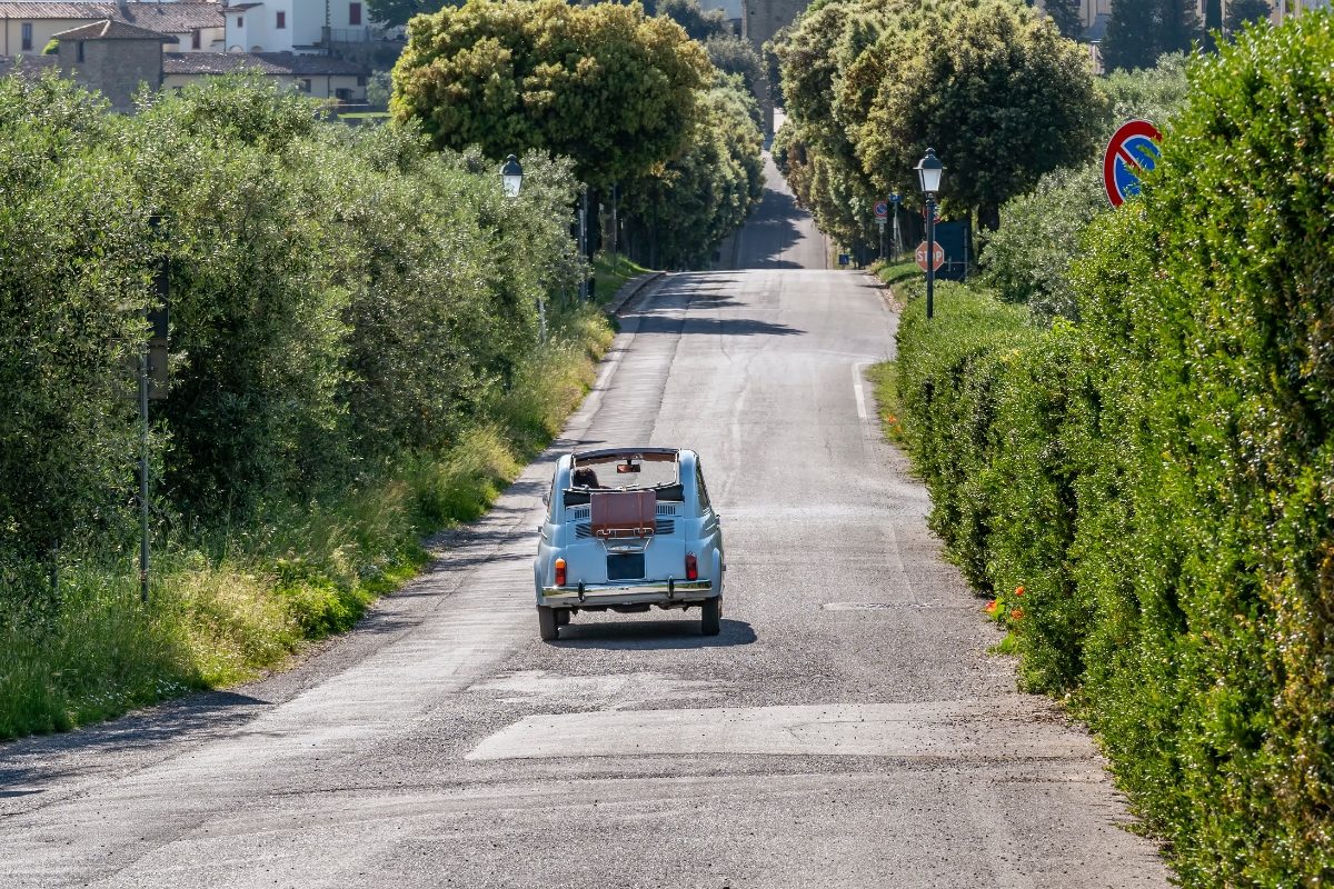 Vintage Italian Fiat 500 convertible car on a road trip at Artimino, Prato, Italy