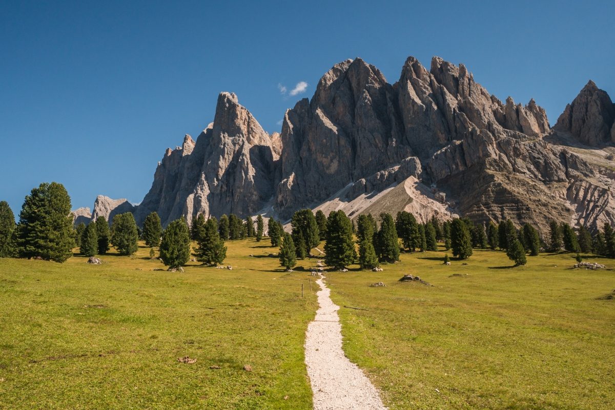 Beautiful trail and the mountain peaks at the Puez-Odle Nature Park in Dolomites, Italy