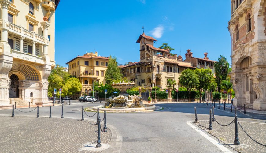 Panoramic view of a fountain and historic buildings in the Quartiere Coppedè in Rome, Italy