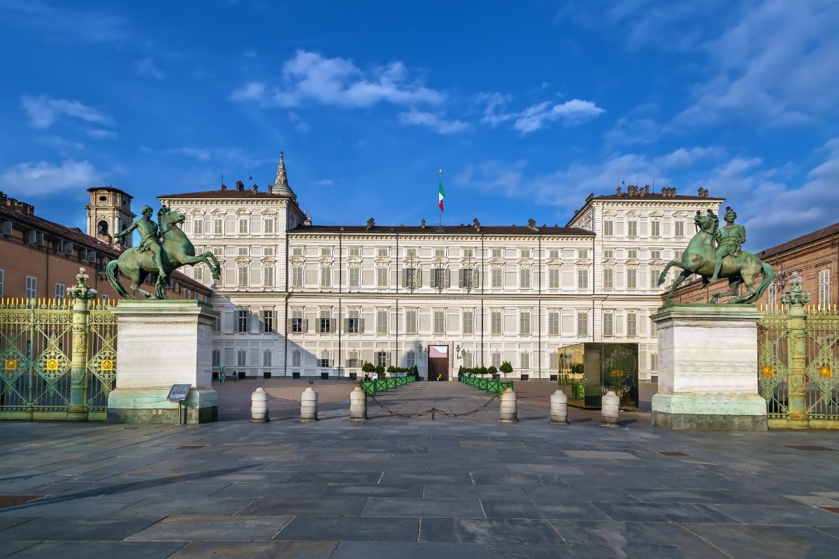 Panoramic view of the Royal Palace of Turin entrance, palace exterior, and skyline in Italy