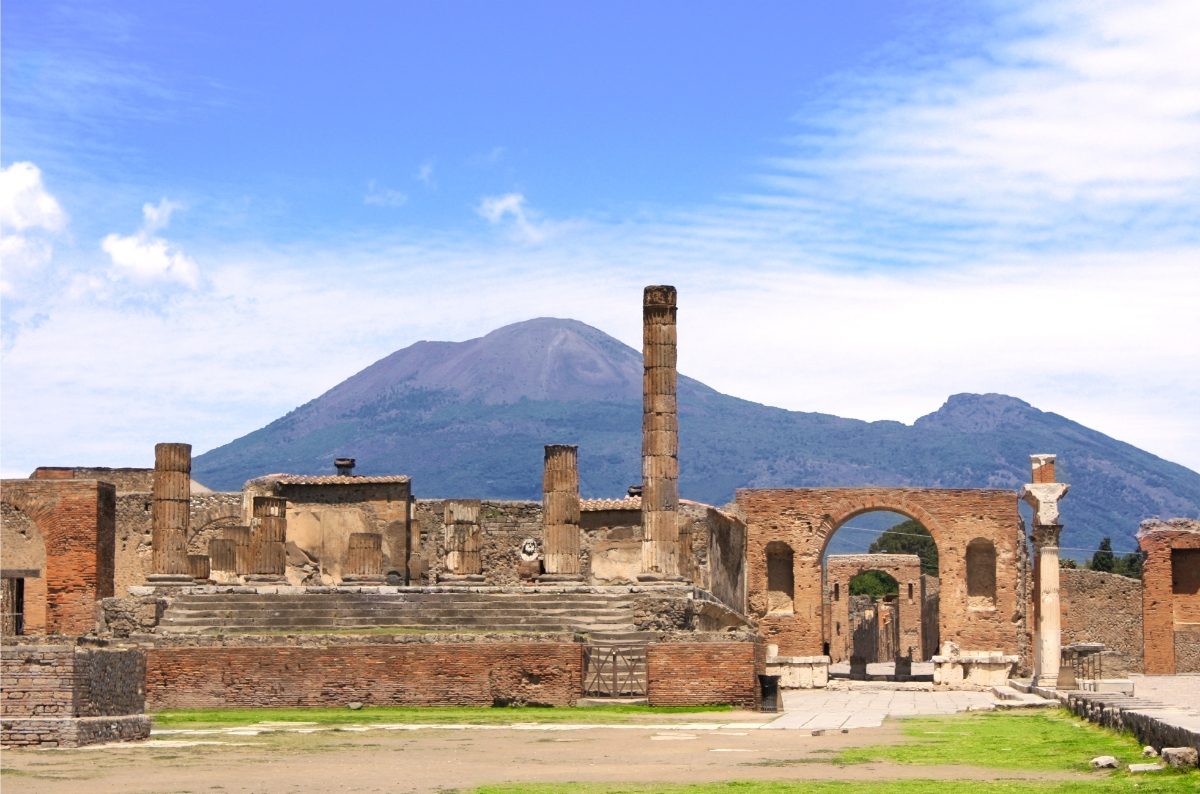 Panoramic view of Pompeii ruins with Mount Vesuvius in the background, showcasing the historical landscape of Naples, Italy