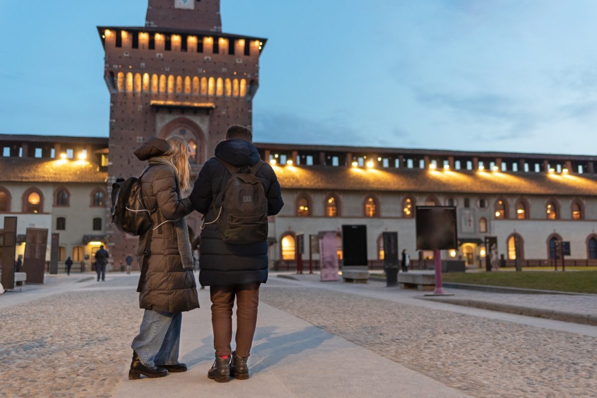 Tourist couple at the Sforza Castle, Milan during the winter