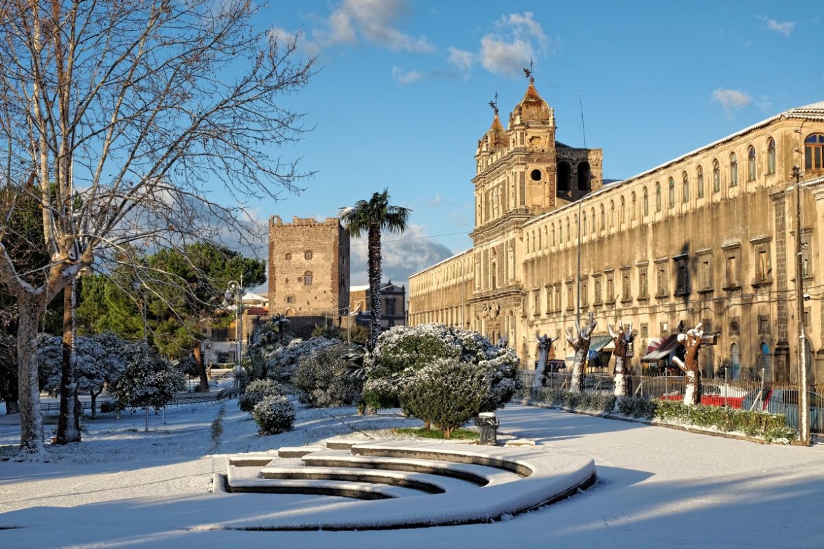 Monastery Of St. Lucy And Norman Castle Of Adrano covered in snow in Sicily, Italy